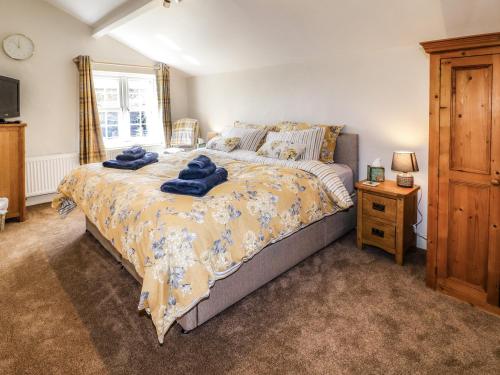 a bedroom with a bed with blue towels on it at Hillcrest in Retford