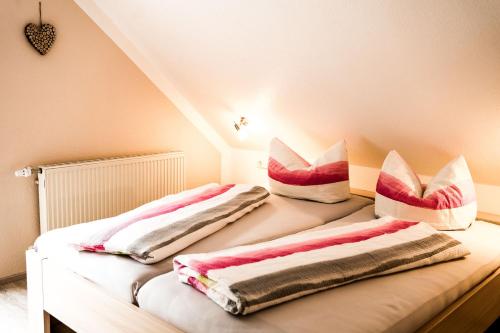 a bedroom with two beds with pillows on them at Paradies im Schwarzwald in Bad Peterstal-Griesbach