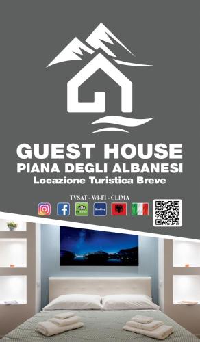 a bedroom with a guest house planelimum address sign on the wall at GUEST HOUSE PIANA DEGLI ALBANESI in Piana degli Albanesi