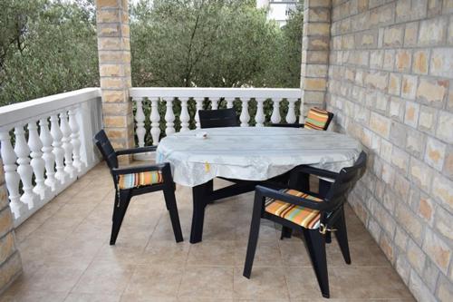 een tafel en 2 stoelen op een patio bij Holiday apartment in Drage with terrace, air conditioning, W-LAN 5013-3 in Drage