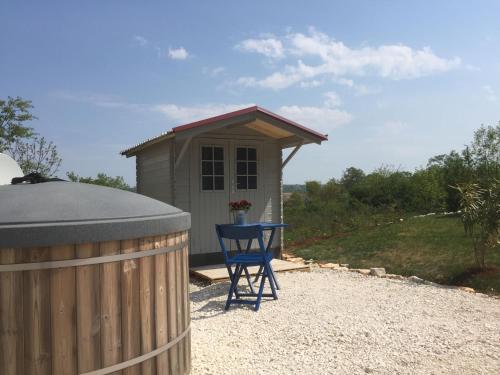 a blue chair sitting in front of a small shed at Istria camp - Istria holiday for 2 in Kringa