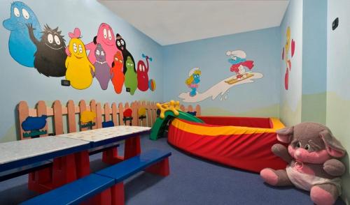 a room with a childs room with a play room with a play room at Ciasa Alpina Relax Hotel in Moena