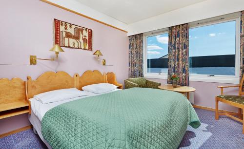 a hotel room with a bed and a window at Storefjell Resort in Gol