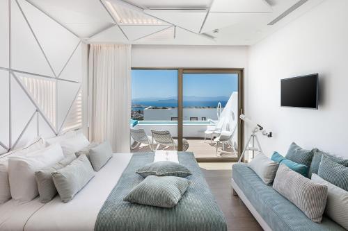a living room with a large bed and a couch at Lagon Life Spirit Boutique Hotel - Adults Only in Chania Town