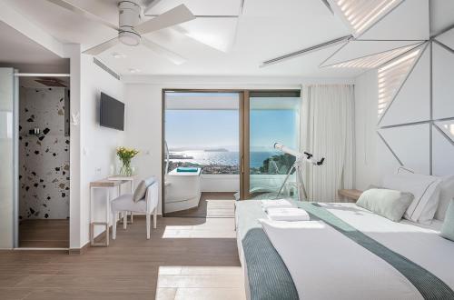 a bedroom with a bed and a view of the ocean at Lagon Life Spirit Boutique Hotel - Adults Only in Chania Town