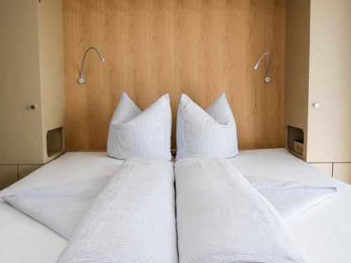 two pillows on a bed in a room at 5Rooms Frühstückspension in Sankt Stefan im Rosental
