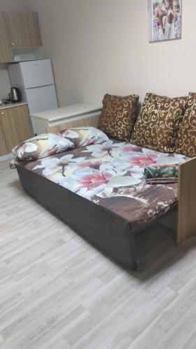 a large bed sitting in a living room next to a couch at Коттедж Науки 65 in Kharkiv