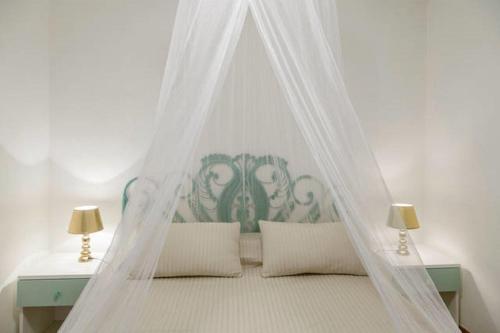 a bed with a canopy in a bedroom at Residenza Costasmeraldina in Porto Rotondo