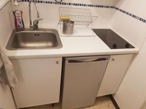 une petite cuisine avec un évier et un évier dans l'établissement Studio plage du môle, au Cap d'Agde