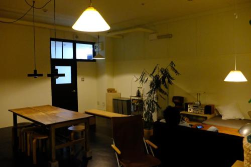 a living room with a table and a couch at Hotel Nupka in Obihiro