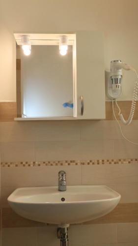 a white sink in a bathroom with a mirror at Villaggio Elisena in Vieste
