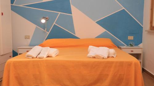 a bedroom with a bed with two towels on it at Villaggio Elisena in Vieste