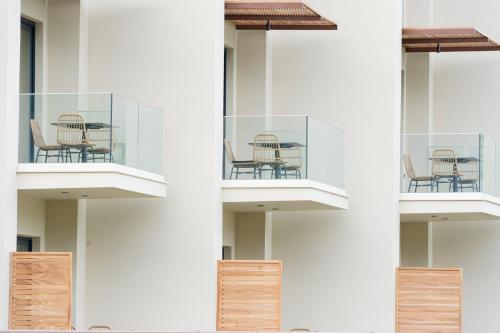 a building with chairs and tables on a balcony at KYVO Experience in Skala Potamias