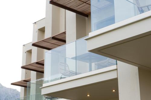 a glass balcony on the side of a building at KYVO Experience in Skala Potamias
