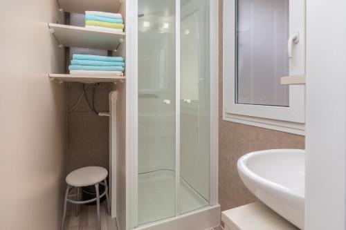 a bathroom with a shower and a toilet and a sink at West Coast Mobilhome with XXL Terrace in Poreč