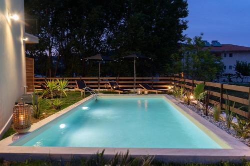 a swimming pool in a backyard at night at KYVO Experience in Skala Potamias
