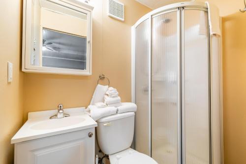 a bathroom with a toilet and a shower at Bayside Cottage Rentals in Port Rowan