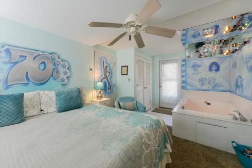 a blue bedroom with a bed and a bath tub and a bed at Summer Nites in North Wildwood