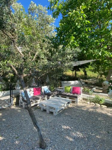 a group of couches and tables in a yard at Sevastie's Home - downstairs in Samothráki