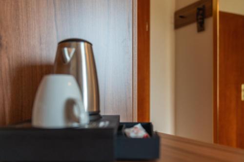 a coffee pot sitting on top of a table at Parkhotel in Bad Waldsee