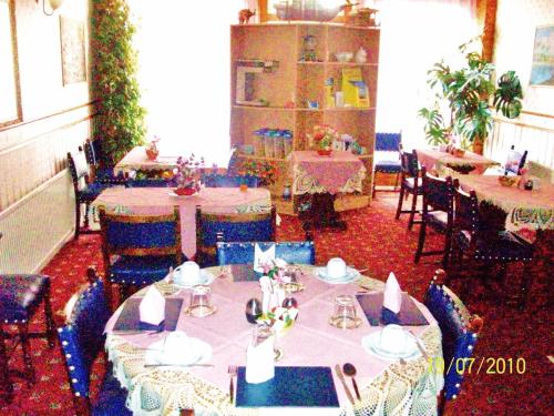 a dining room with tables and chairs in a room at Galway Guest House in Weymouth