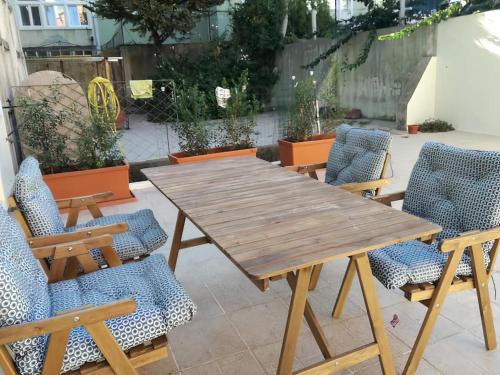 a wooden table and chairs on a patio at The Albuquerque Suites Self Check in in Lisbon