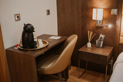 a hotel room with a desk with a cup of coffee on it at Seven Dreams Suites in Lisbon