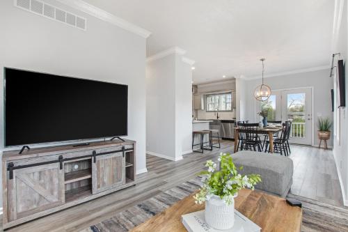 a living room with a large flat screen tv at Practically Perfect in South Haven