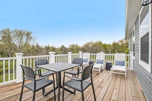 a patio with chairs and a table on a deck at Practically Perfect in South Haven