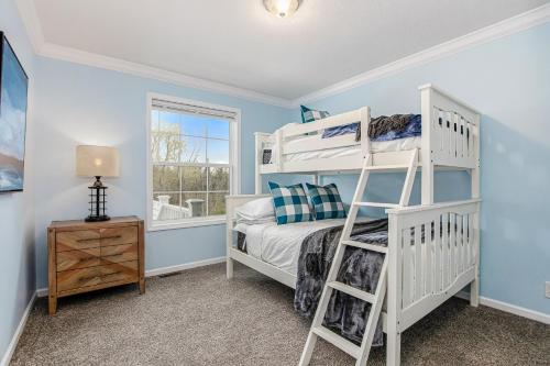 a bedroom with a bunk bed and a window at Practically Perfect in South Haven