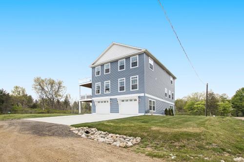 a large gray house with a white garage at Practically Perfect in South Haven