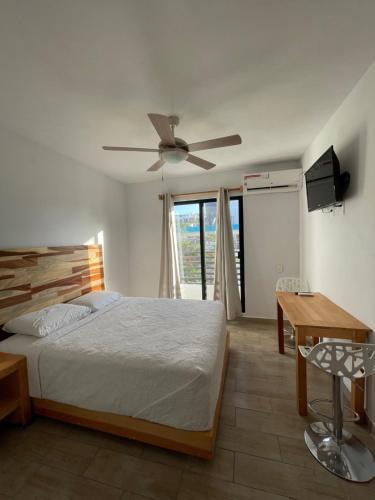 a bedroom with a bed and a ceiling fan at SuitesMB in Playa del Carmen