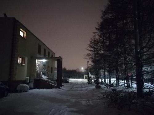 a building in the snow at night at Hostel Los Amigos in Rzeszów