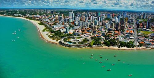 an aerial view of a city and a beach at Imperial Flat Tambaú - João Pessoa in João Pessoa