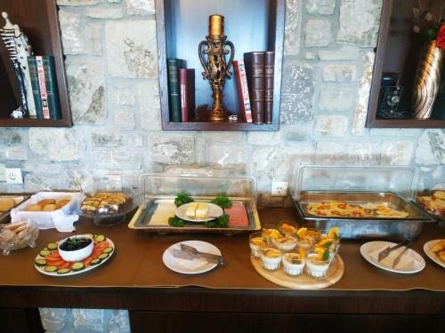 a table with several trays of food on it at Χρυσοπελεια - Chrisopeleia Lake View in Neochori