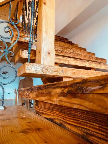 a close up of a wooden staircase in a house at PANORAMIC Sus In Deal in Vişeu de Jos