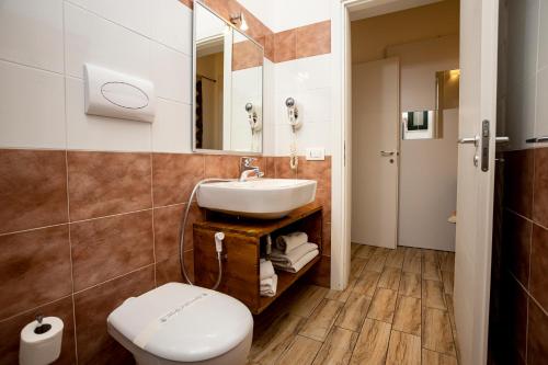 a bathroom with a sink and a toilet at Trapani Home in Trapani