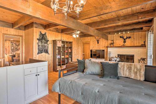 a living room with a couch and a fireplace at A-Frame Home with 3 Decks and Lake Arrowhead Views! in Lake Arrowhead