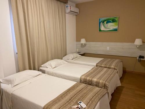 a hotel room with two beds at Camaçari Plaza Hotel in Camaçari