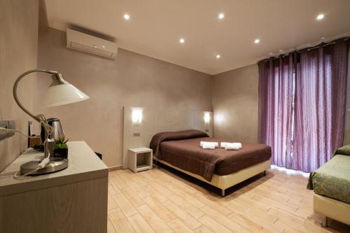 A bed or beds in a room at Nanà