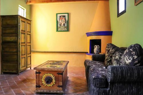 a living room with a couch and a fireplace at Mirador del Frayle in San Miguel de Allende