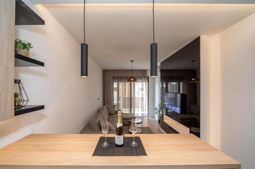 a dining room with a table with wine glasses at Soho City A403 in Bar