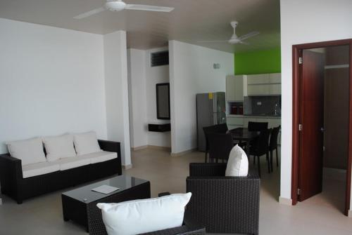 a living room with a couch and chairs and a table at Apartamento Quinta Avenida in Melgar