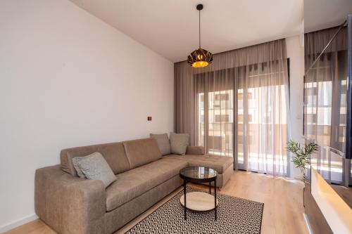 a living room with a couch and a table at Soho City A403 in Bar