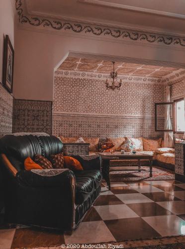 a living room with a couch and a table at Casa Medina Sanaa in Tetouan