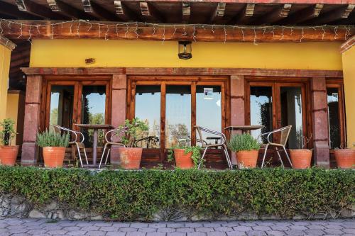 a group of chairs and tables in front of a building at Mirador del Frayle in San Miguel de Allende