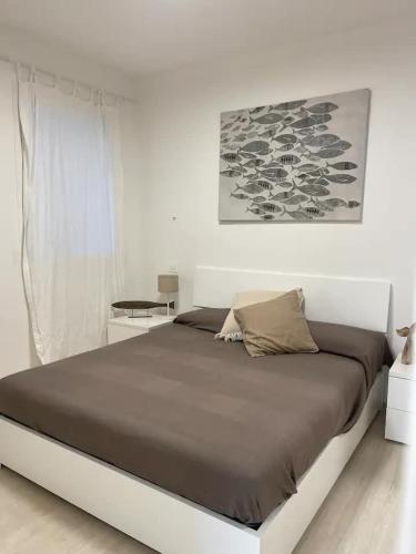a bedroom with a large bed in a white room at Tenuta le marze in Castiglione della Pescaia
