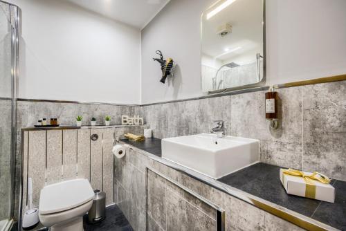 a bathroom with a sink and a toilet at Villare Leicester City Centre hotel in Leicester