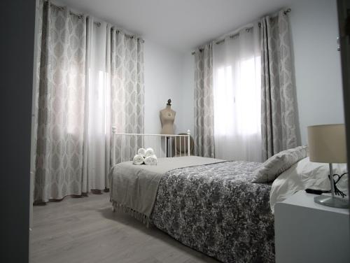 a bedroom with a bed with two teddy bears on it at Casa Vera in Roquetas