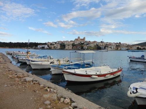a group of boats are docked in a harbor at Galaxa Mansion in Galaxidhion